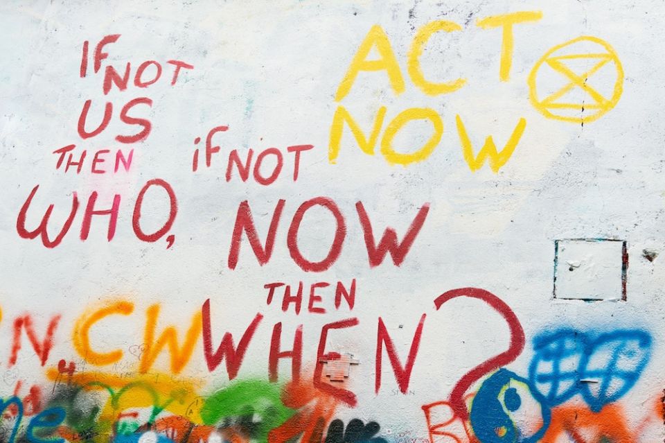 Wall painting that says "If not us, then who, if not now, then when?" (Unsplash/Rod Long)