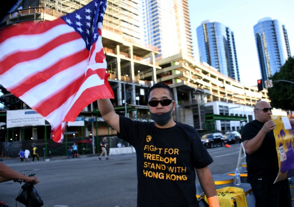 A fan wears a T-shirt supporting Hong Kong and holds a U.S. flag before an NBA game between the Los Angeles Lakers and the LA Clippers in that city Oct. 22. (Newscom/USA Today Sports/Kirby Lee)
