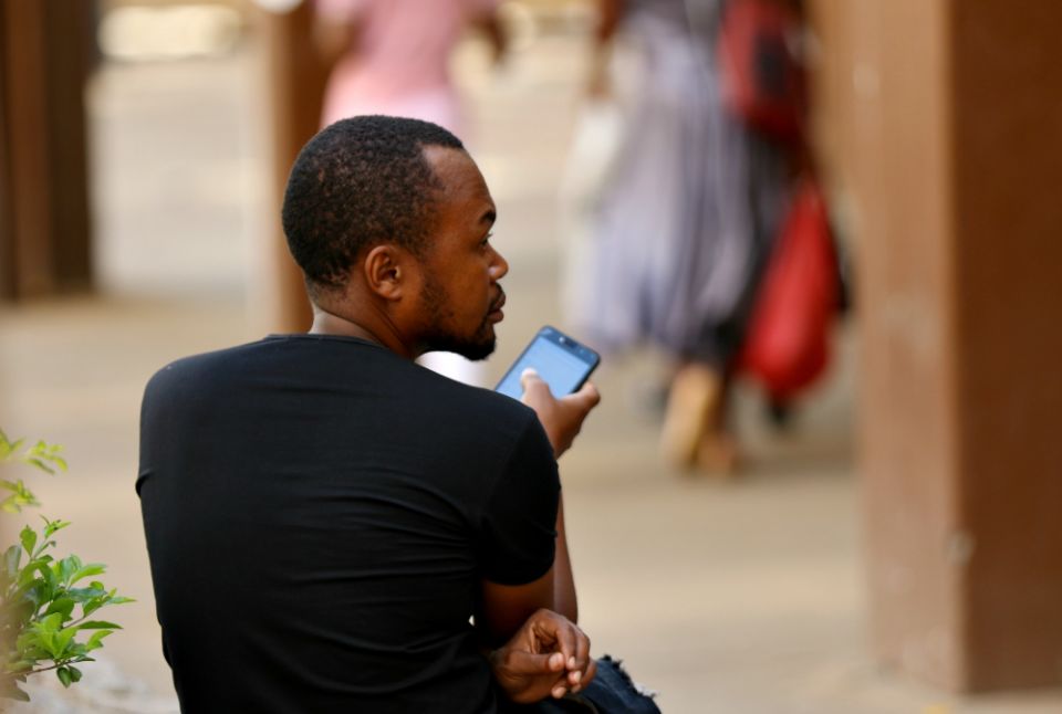 A man checks his mobile phone in Harare, Zimbabwe, in January. (Newscom/Reuters/Philimon Bulawayo) A man checks his mobile phone in Harare, Zimbabwe, in January. (Newscom/Reuters/Philimon Bulawayo)