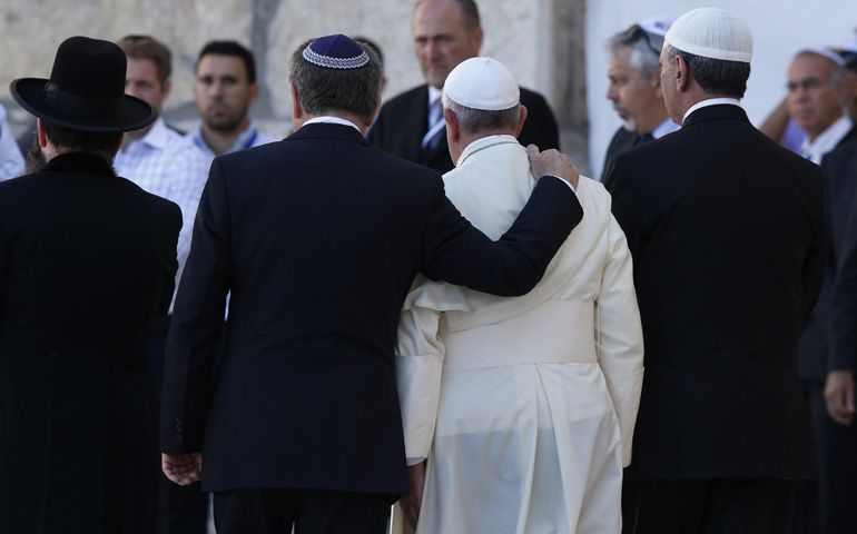 Argentine Rabbi Abraham Skorka embraces Pope Francis as they leave after praying at Jerusalem's Western Wall Jerusalem in 2014. On the right is Omar Abboud, a Muslim leader from Argentina. (CNS/Paul Haring)