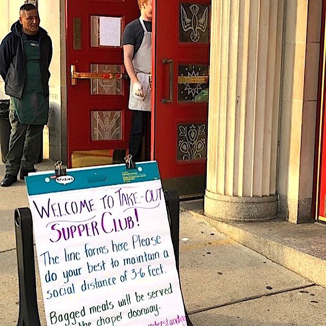 Sidewalk sign inviting homeless diners to a free take-out dinner at the Paulist Center in Boston (Susan Rutkowski)