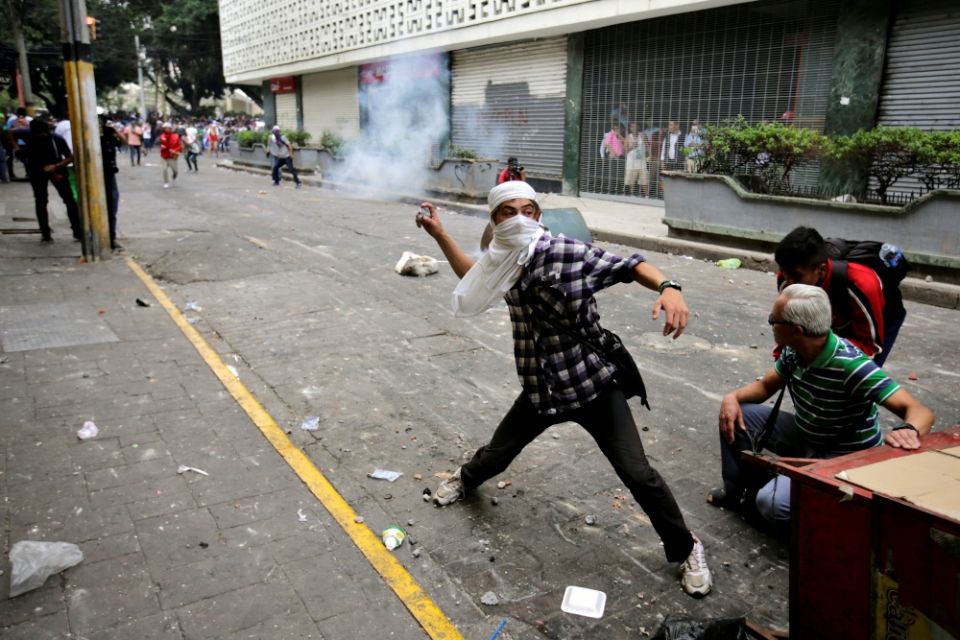 A demonstrator throws a tear gas canister back to riot police April 30 in Tegucigalpa, Honduras, during a protest against government plans to privatize health care and education. (CNS/Reuters/Jorge Cabrera) A demonstrator throws a tear gas canister back to riot police April 30 in Tegucigalpa, Honduras, during a protest against government plans to privatize health care and education. (CNS/Reuters/Jorge Cabrera)