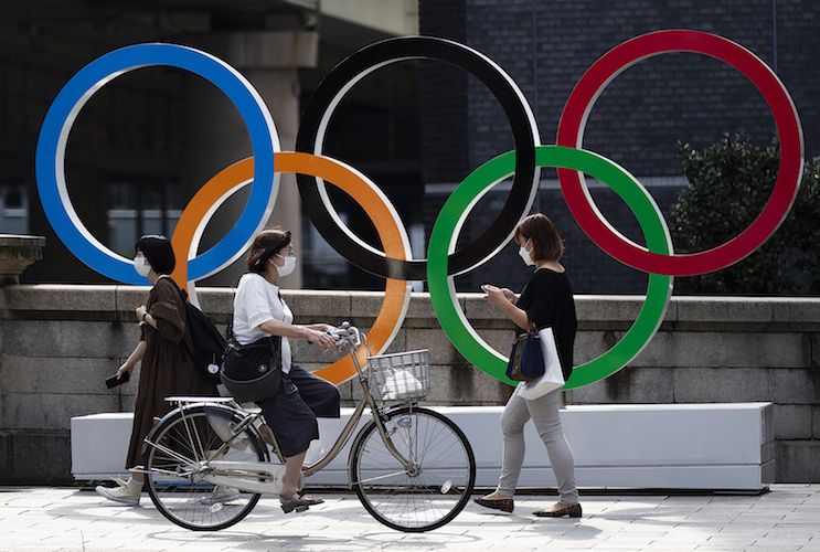 People walk by the Olympic rings installed by the Nippon Bashi bridge in Tokyo on Thursday, July 15, 2021. (AP Photo/Hiro Komae) People walk by the Olympic rings installed by the Nippon Bashi bridge in Tokyo on Thursday, July 15, 2021. (AP Photo/Hiro Komae)