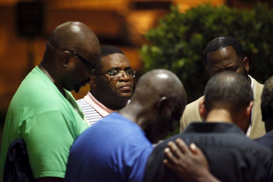 A small prayer circle forms nearby where police responded to a shooting at the Emanuel AME Church in Charleston, South Carolina, June 17, 2015. (CNS/Reuters/Randall Hill)