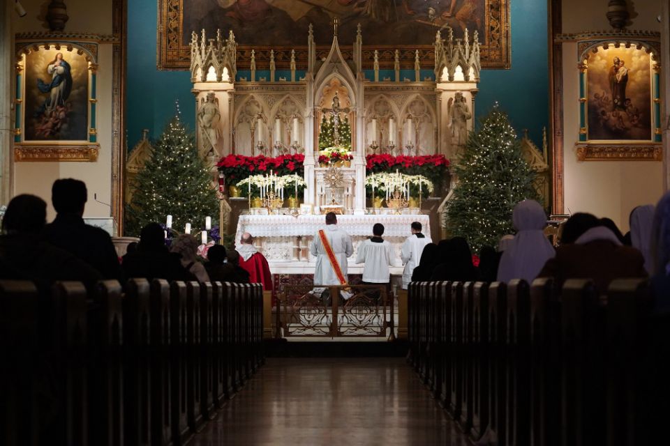Worshipers kneel in prayer during eucharistic adoration following a Mass marking the feast of the Holy Innocents Dec. 28, 2020, at the Church of the Holy Innocents in New York City. (CNS/Gregory A. Shemitz)