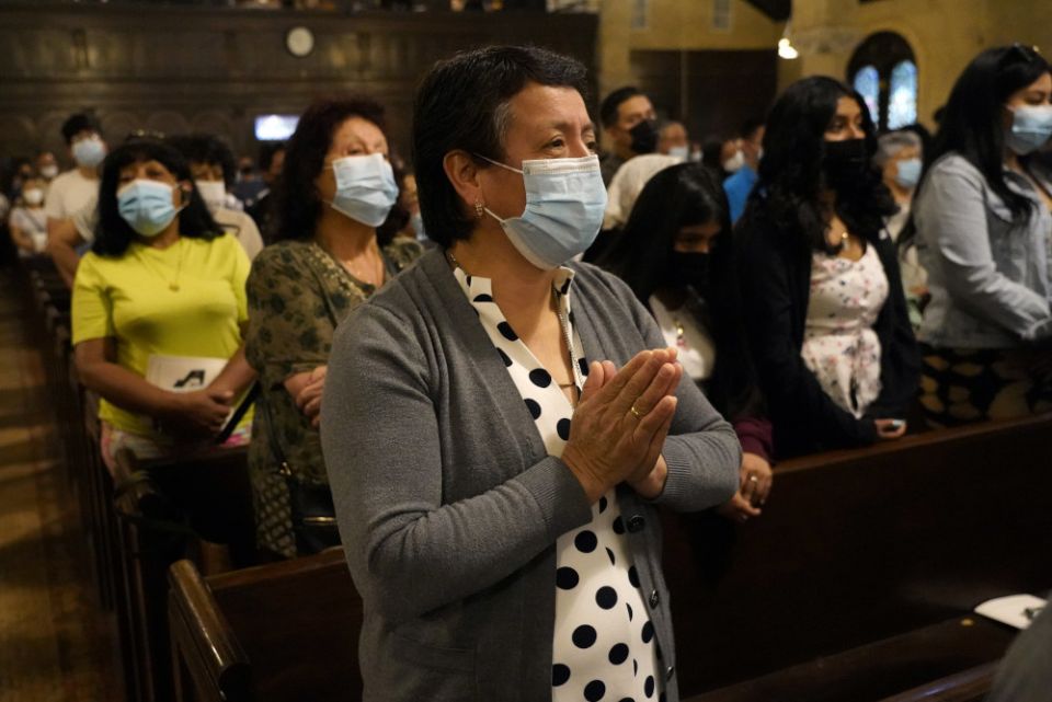 A woman prays during the formal installation of Fr. Carlos C. Velasquez as pastor of St. Brigid Church in the Brooklyn borough of New York City June 20. (CNS/Gregory A. Shemitz)