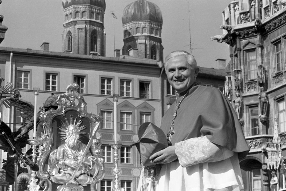 With the towers of Munich's cathedral in the background, Cardinal Joseph Ratzinger, later Pope Benedict XVI, bids farewell to the Bavarian believers on Feb. 28, 1982, in downtown Munich, Germany. (AP file/Dieter Endlicher)