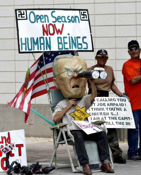 A man wears a mask of Joe Arpaio, then-sheriff of Maricopa County, during a protest against S.B. 1070, Arizona's immigration law, outside the U.S. District Court in Phoenix in 2010. (CNS/Reuters/Joshua Lott)