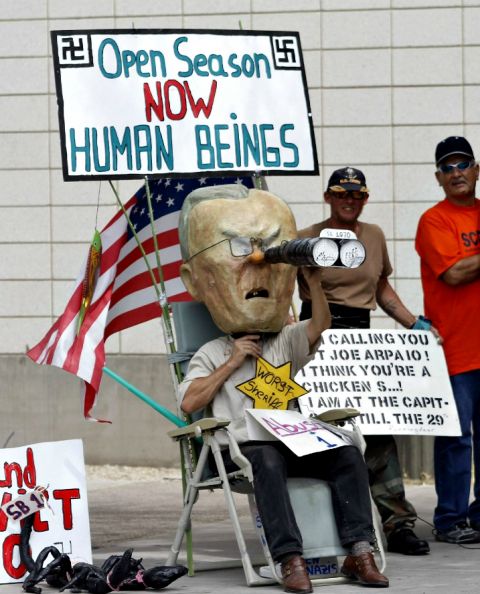 A man wears a mask of Joe Arpaio, then-sheriff of Maricopa County, during a protest against S.B. 1070, Arizona's immigration law, outside the U.S. District Court in Phoenix in 2010. (CNS/Reuters/Joshua Lott) A man wears a mask of Joe Arpaio, then-sheriff of Maricopa County, during a protest against S.B. 1070, Arizona's immigration law, outside the U.S. District Court in Phoenix in 2010. (CNS/Reuters/Joshua Lott)