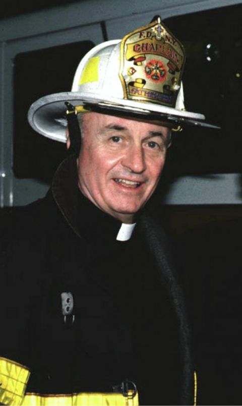 Fr. Mychal Judge is pictured in an undated photo wearing his helmet and bunker coat. (CNS/Courtesy of Holy Name Province Franciscans)