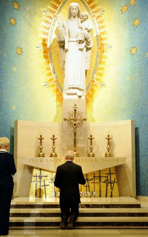 In September 2011, Vice President Joe Biden kneels in the chapel of Our Lady of Siluva at the Basilica of the National Shrine of the Immaculate Conception following a memorial Mass for Vatican diplomat Archbishop Pietro Sambi in Washington. (CNS)