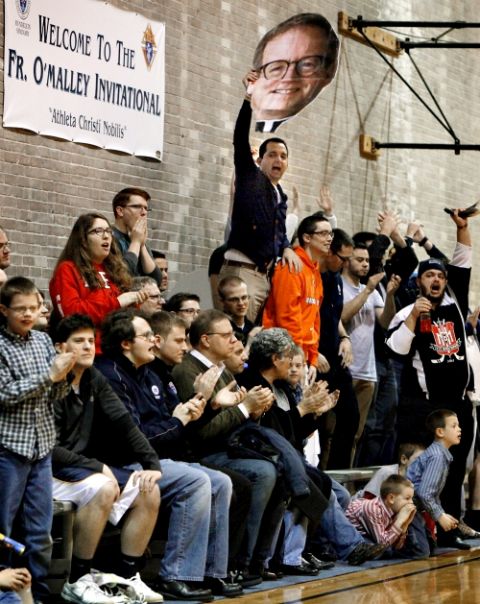 A fan holds up a face of then-Fr. Robert Barron, at the time rector/president of the University of St. Mary of the Lake Seminary in Mundelein, Illinois, as they cheer their team on during a basketball game. (CNS/Catholic New World/Karen Callaway)