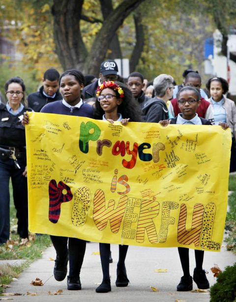 Escorted by Chicago police, students from the Academy of St. Benedict the African School in Chicago conduct a prayer walk for peace in their community in 2015. (CNS/Catholic New World/Karen Callaway)