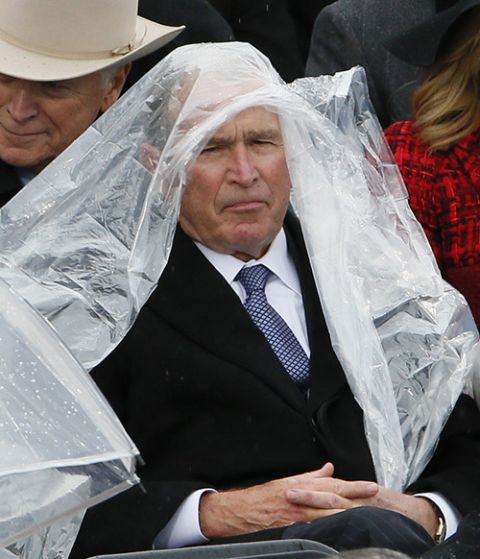 Former President George W. Bush keeps covered in the rain during Donald Trump's presidential inauguration Jan. 20, 2017, at the U.S. Capitol in Washington. (CNS/Reuters/Rick Wilking)