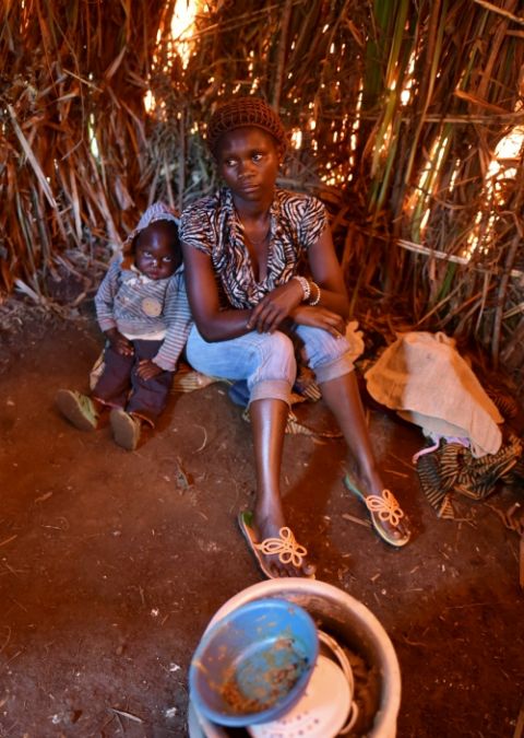 An internally displaced Congolese woman and her child sit inside a makeshift shelter at a camp for victims of ethnic violence in Ituri, Congo, June 24, 2019. (CNS/Reuters/Olivia Acland)