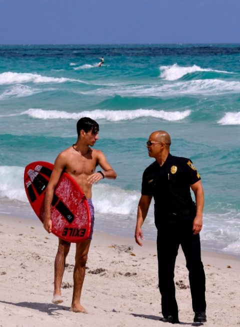 A police officer in Miami talks to a tourist about the closing of the beach due to coronavirus March 19. (CNS/Reuters/Maria Alejandra Cardona) A police officer in Miami talks to a tourist about the closing of the beach due to coronavirus March 19. (CNS/Reuters/Maria Alejandra Cardona)