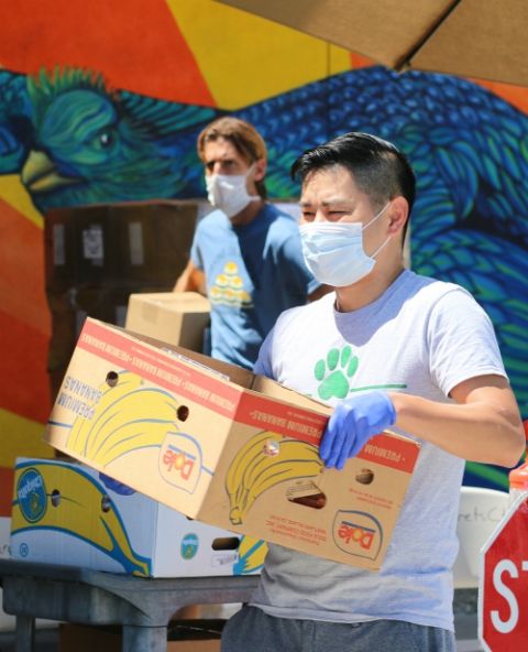 Workers at St. Margaret's Center in Lennox, California, carry boxes of food to people's cars April 15. The Catholic Charities center has been open on Wednesdays for food pickups by appointment. (CNS/The Angelus News/Courtesy of Pablo Kay)