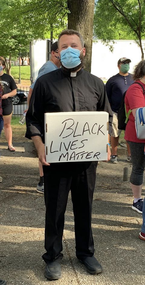Fr. Joshua Laws, pastor of the Catholic Community of South Baltimore, holds a "Black Lives Matter" sign before the start of an interfaith prayer vigil in Baltimore June 3, 2020. (CNS/Catholic Review/Tim Swift) Fr. Joshua Laws, pastor of the Catholic Community of South Baltimore, holds a "Black Lives Matter" sign before the start of an interfaith prayer vigil in Baltimore June 3, 2020. (CNS/Catholic Review/Tim Swift)