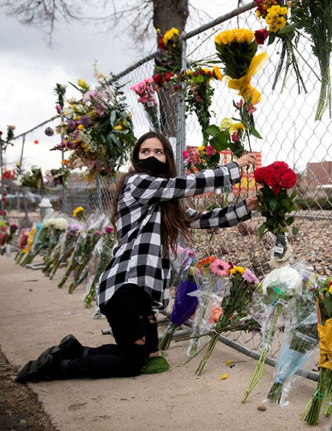 Morgan Beltzer, 14, of Broomfield, Colorado, leaves flowers at King Soopers grocery store March 23, the site of a mass shooting that killed 10 people the previous day. (CNS/Reuters/Alyson McClaran)