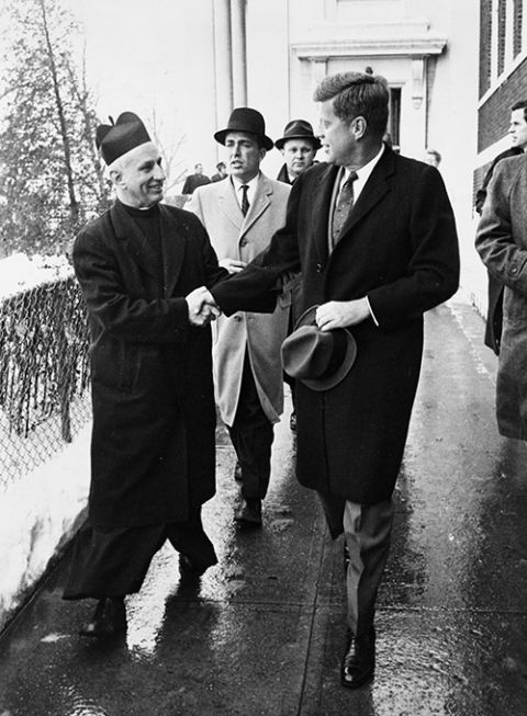 President-elect John F. Kennedy shakes hands with Fr. Richard Casey, pastor of Holy Trinity Church, after attending Mass at the church prior to inauguration ceremonies in Washington Jan. 20, 1961. (CNS/Library of Congress Prints and Photographs Division)