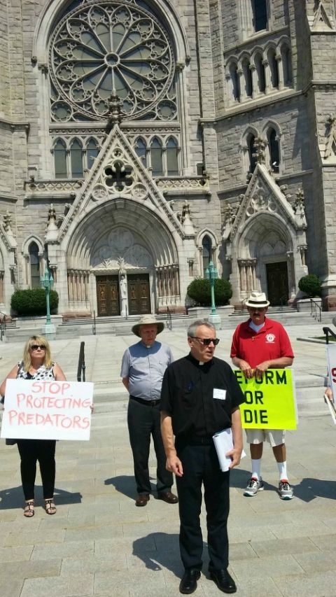 On Aug. 29, 2018, in front of Sacred Heart Basilica Cathedral in Newark, New Jersey, Fr. Desmond Rossi leads a prayer demonstration about the Catholic Church's handling of clergy sexual abuse. (NCR photo/Peter Feuerherd)