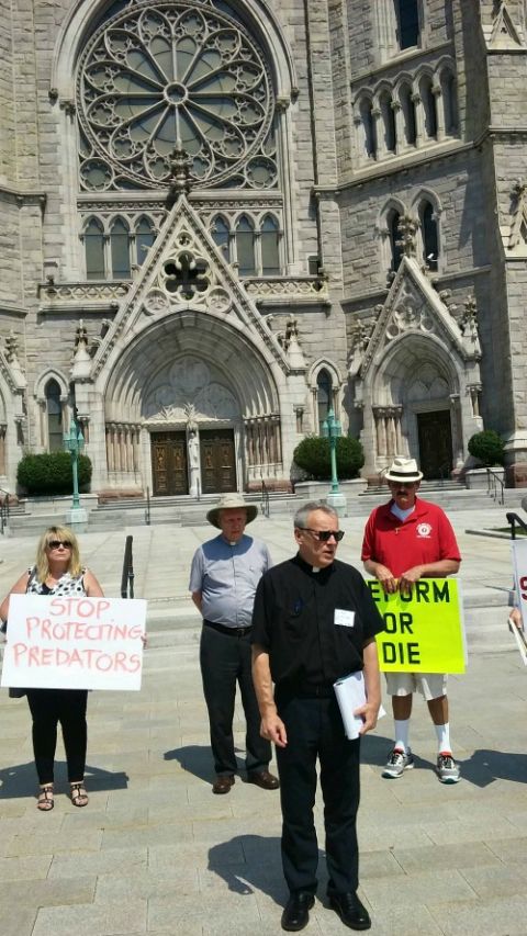 On Aug. 29, 2018, in front of Sacred Heart Basilica Cathedral in Newark, New Jersey, Fr. Desmond Rossi leads a prayer demonstration about the Catholic Church's handling of clergy sexual abuse. (NCR photo/Peter Feuerherd) On Aug. 29, 2018, in front of Sacred Heart Basilica Cathedral in Newark, New Jersey, Fr. Desmond Rossi leads a prayer demonstration about the Catholic Church's handling of clergy sexual abuse. (NCR photo/Peter Feuerherd)
