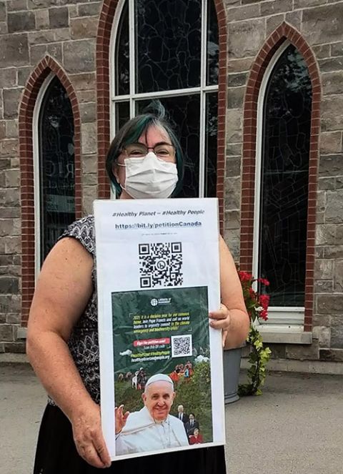 Agnes Richard collects signatures for the People and Planet First (Development and Peace) campaign in front of her parish, St. Patrick's, in Caledonia, Ontario, in fall 2021. (Courtesy of Agnes Richard)