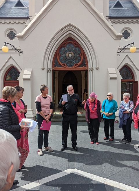 Fr. Chris Denham, dean of St. Patrick's Cathedral in Auckland, greets participants at the "Pink Shoes into the Vatican" event in that city on Sept. 18 (Courtesy of Luc Powell)