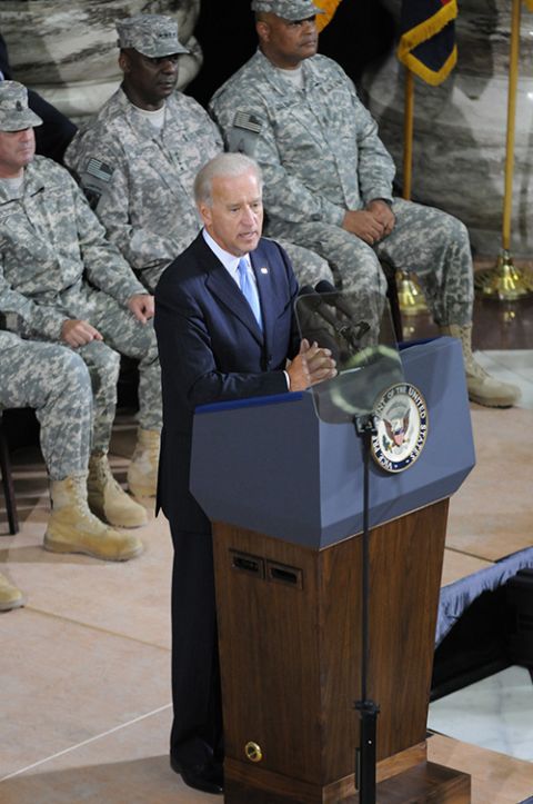Then-Vice President Joe Biden speaks in Iraq in 2010 at a ceremony in which Gen. Lloyd Austin (seated, center) took command of the United States Forces-Iraq. (DVIDS/SFC Roger Dey)