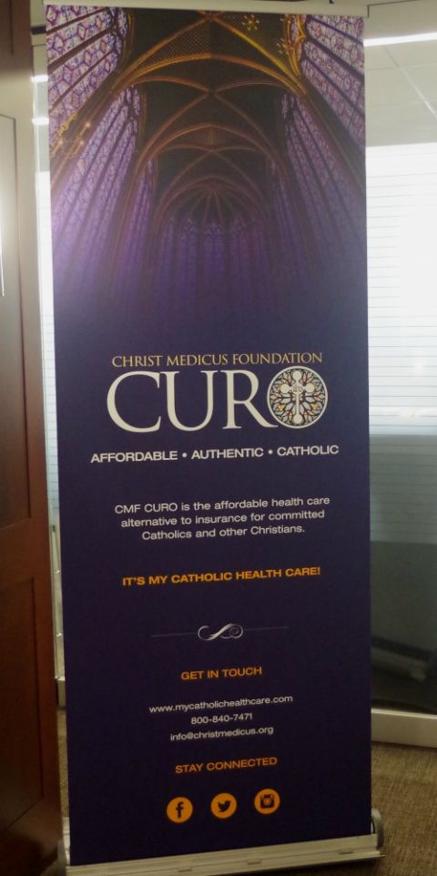 A banner is displayed at a 2017 CMF Curo event. (CMF Curo/Courtesy of BringingHeart/Kathy Dempsey)