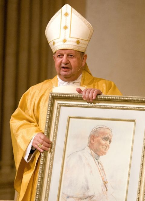 Polish Cardinal Stanislaw Dziwisz presents a framed portrait of St. John Paul II to members of St. Patrick Parish in Miami Beach Feb. 3, 2005. (CNS/Tom Tracy)