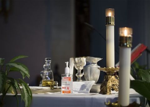 A bottle of hand sanitizer is seen on the altar prior to Mass at St. Gabriel Catholic Church in Washington July 11. (CNS/Tyler Orsburn)