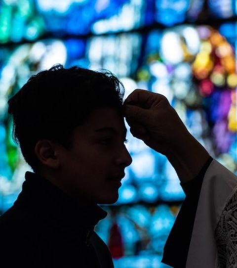 A person receives ashes on his forehead during Ash Wednesday Mass at Sts. Peter and Paul Church in Green Bay, Wisconsin. The Vatican has asked priests to take special anti-COVID-19 precautions this year. (CNS/The Compass/Sam Lucero)