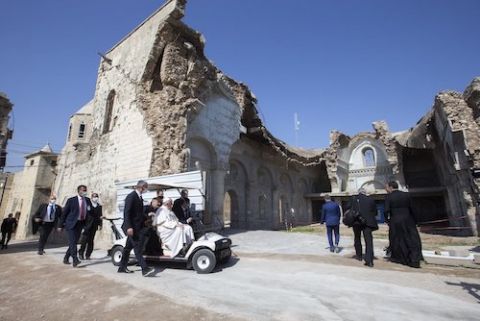 Pope Francis arrives in a golf cart to visit the destroyed Al-Tahera Syriac Catholic Church in Mosul, Iraq, March 7, 2021. (CNS/Paul Haring)