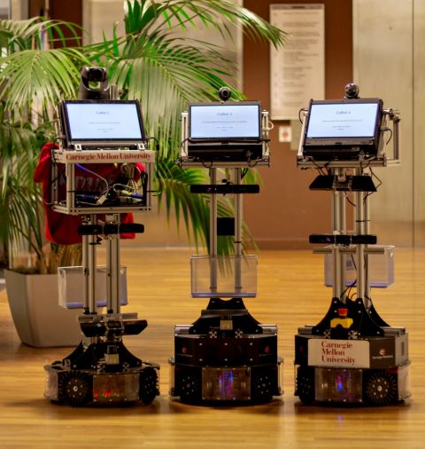 Three of the autonomous mobile CoBots developed at Carnegie Mellon University (Carnegie Mellon University) Three of the autonomous mobile CoBots developed at Carnegie Mellon University (Carnegie Mellon University)