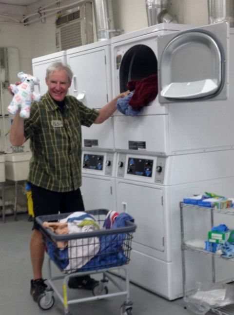 Peter Wise, a volunteer from the San Francisco Bay Area, helped with the essential behind-the-scenes work at Annunciation House in El Paso, Texas: washing tons of bedding, clothing and, occasionally, a stuffed animal. (Petrina Grube)