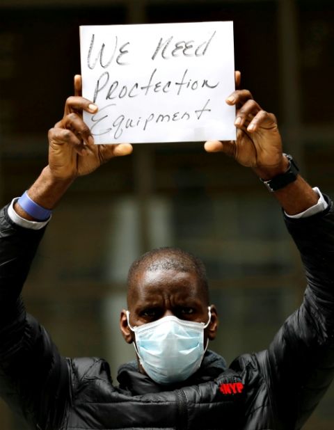 A health care worker takes part in a demonstration as part of a national day of action calling on federal and local authorities to provide more personal protective equipment and support outside New York-Presbyterian Medical Center in New York City April 9