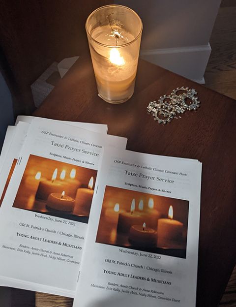 Programs set out for a collaborative young adult Taizé and happy hour event hosted in June 2022 by Catholic Climate Covenant and Old St. Patrick's Catholic Church in Chicago. (Courtesy of Anna Robertson)