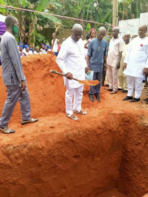 Paschal Anyibgo pours red earth in the grave as a mark of respect and final farewell to his father. (Provided photo)