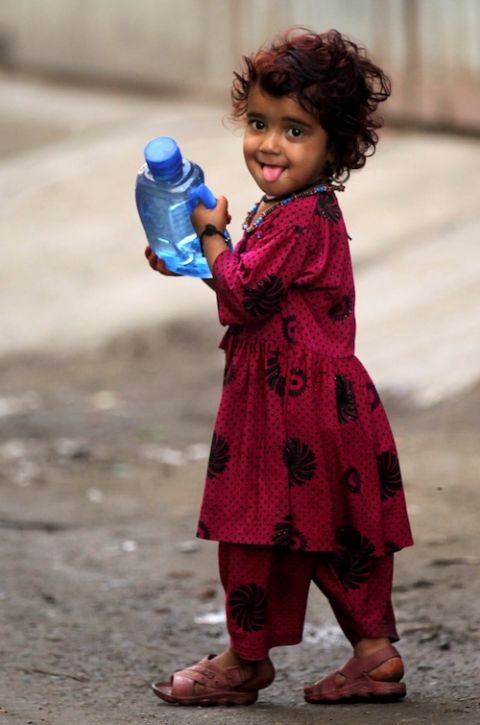 An Afghan refugee girl walks along a road in Lahore, Pakistan, in 2019. Pope Francis has cautioned about depletion of the world's freshwater supplies. (CNS photo/Mohsin Raza, Reuters)