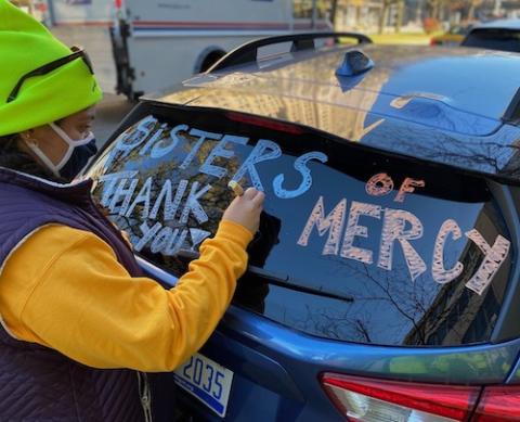 Jesuit Volunteer Salena Ibrahim inscribes thanks on a Sisters of Mercy automobile participating in defending Detroit election Nov. 3. (Courtesy of Sr. Erin McDonald, CSJ) Jesuit Volunteer Salena Ibrahim inscribes thanks on a Sisters of Mercy automobile participating in defending Detroit election Nov. 3. (Courtesy of Sr. Erin McDonald, CSJ)