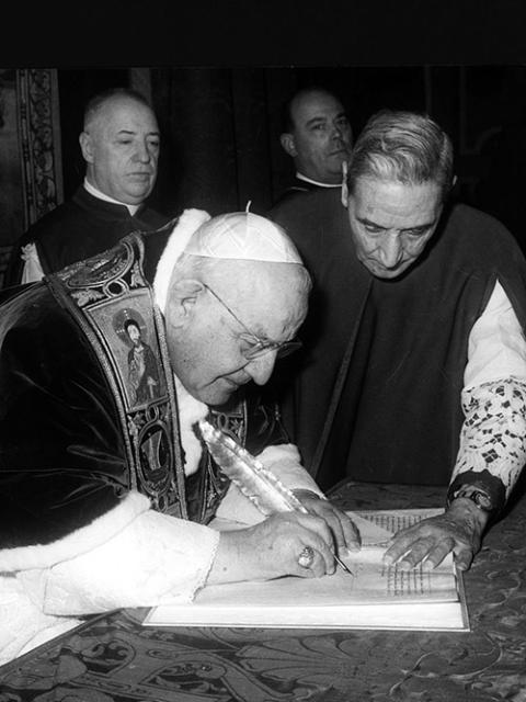 Pope John XXIII signs a papal bull opening the Second Vatican Council in 1962. (CNS)