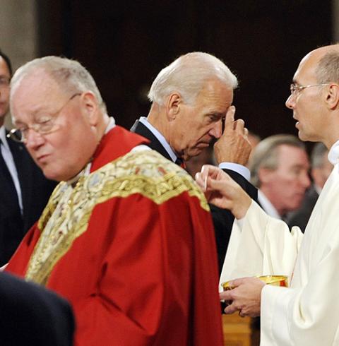 Then-Vice President Joe Biden makes the sign of the cross after receiving Communion during a Mass in 2011 at the Basilica of the National Shrine of the Immaculate Conception in Washington. (CNS/Leslie E. Kossoff)