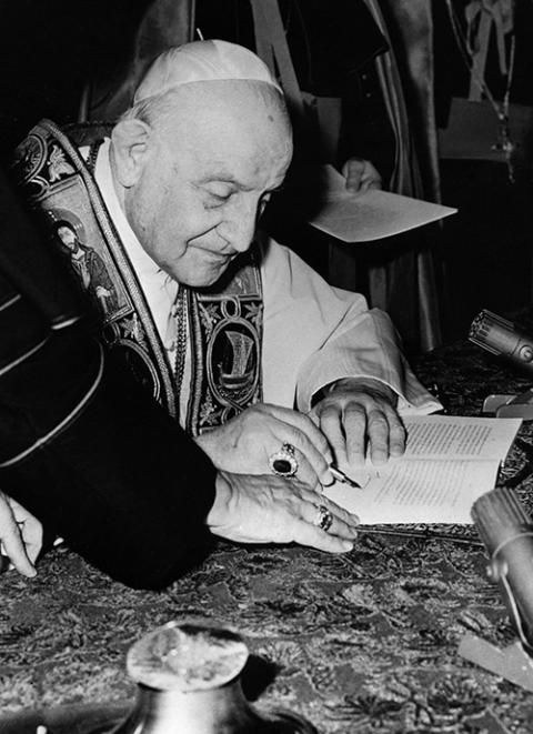 Pope John XXIII signs his encyclical "Peace on Earth" ("Pacem in Terris") at the Vatican in this 1963 file photo. (CNS photo) Pope John XXIII signs his encyclical "Peace on Earth" ("Pacem in Terris") at the Vatican in this 1963 file photo. (CNS photo)