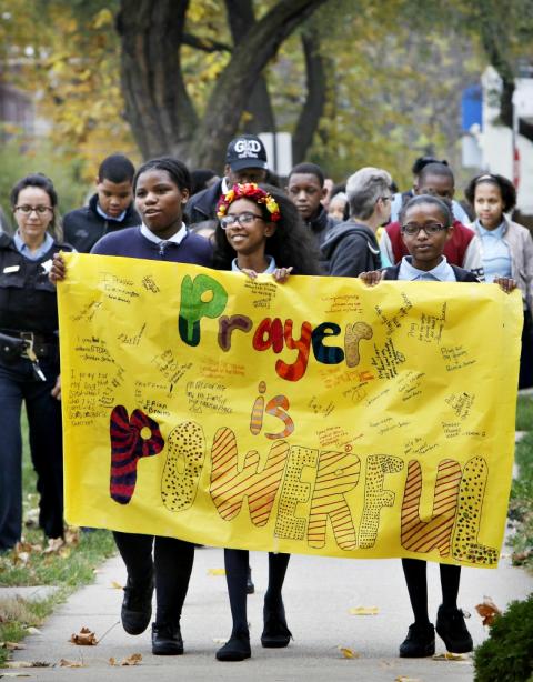 Escorted by Chicago police, students from the Academy of St. Benedict the African School in Chicago conduct a prayer walk for peace in their community in 2015. (CNS/Catholic New World/Karen Callaway) Escorted by Chicago police, students from the Academy of St. Benedict the African School in Chicago conduct a prayer walk for peace in their community in 2015. (CNS/Catholic New World/Karen Callaway)
