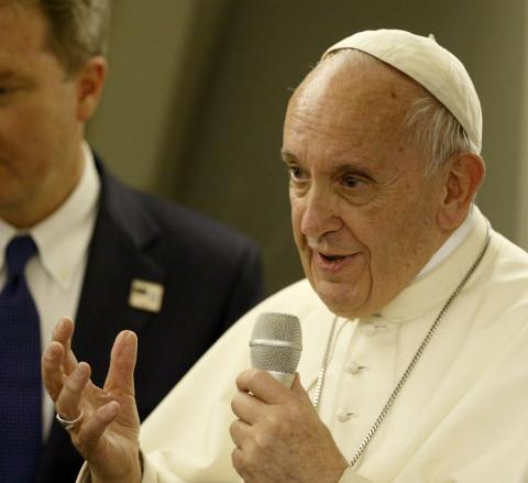 Pope Francis answers questions from journalists aboard his flight from Dhaka, Bangladesh, to Rome Dec. 2. (CNS/Paul Haring)