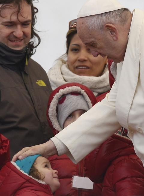 Pope Francis greets a child during his general audience in St. Peter's Square at the Vatican Feb. 14. (CNS/Paul Haring)