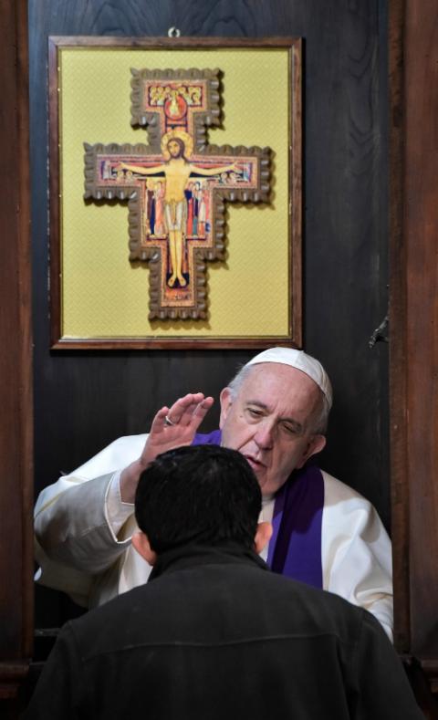 Pope Francis hears the confession of a priest at Rome's Basilica of St. John Lateran in March 2019. (CNS/Vatican Media)