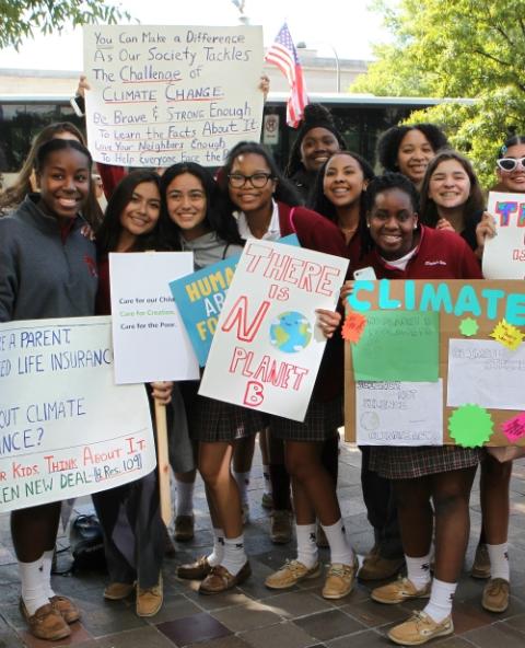 Juniors and seniors from environmental science classes at Elizabeth Seton High School, a girls school in Bladensburg, Maryland, stand with their climate change signs along Constitution Avenue in Washington Sept. 20, 2019. (CNS)