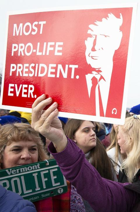 A demonstrator holds an image of President Donald Trump during the March for Life rally in Washington Jan. 24. (CNS/Tyler Orsburn)